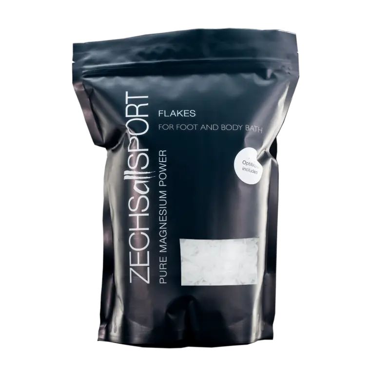 Schwarzer Beutel mit Produktflocken. Aufschrift: Zechsallsport, Flocken für Fuß- und Körperbad, reines Magnesium Power. Optima-Logo.