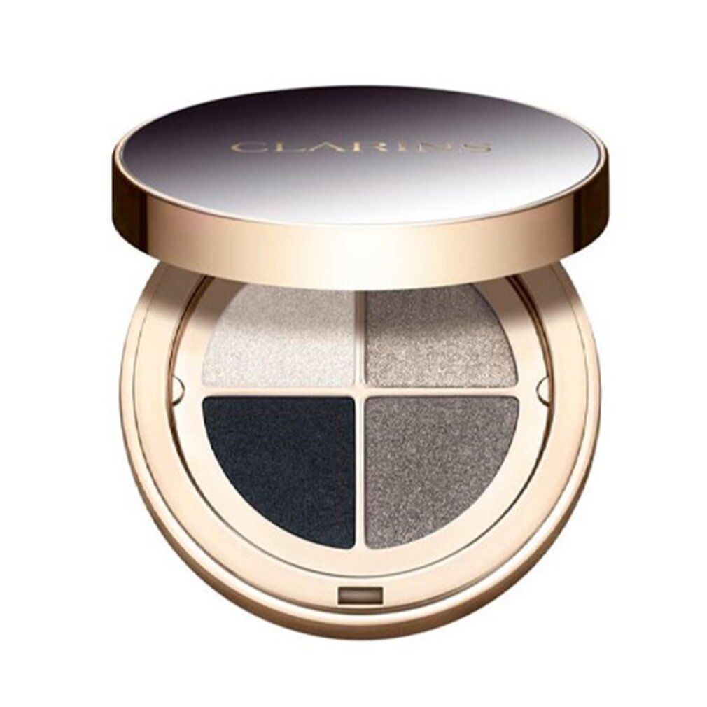 Runde Lidschatten-Palette mit vier Farben. Deckel geöffnet. Farben: Weiß, Grau, Dunkelgrau und Schwarz. Goldfarbener Rahmen.