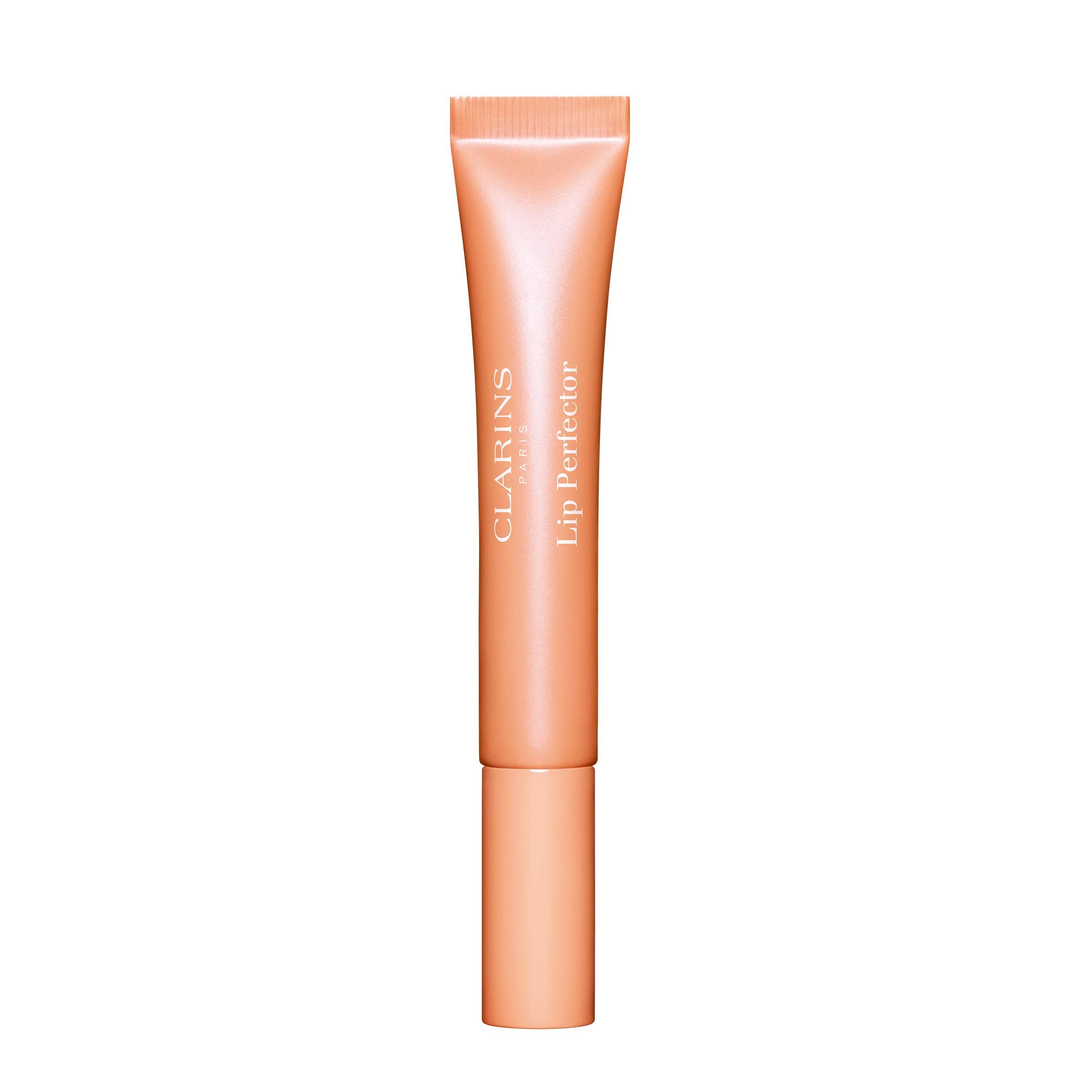 Clarins Lip Perfector in Pfirsich-Farbe. Tube mit Schraubverschluss. Produktname und Marke deutlich sichtbar.