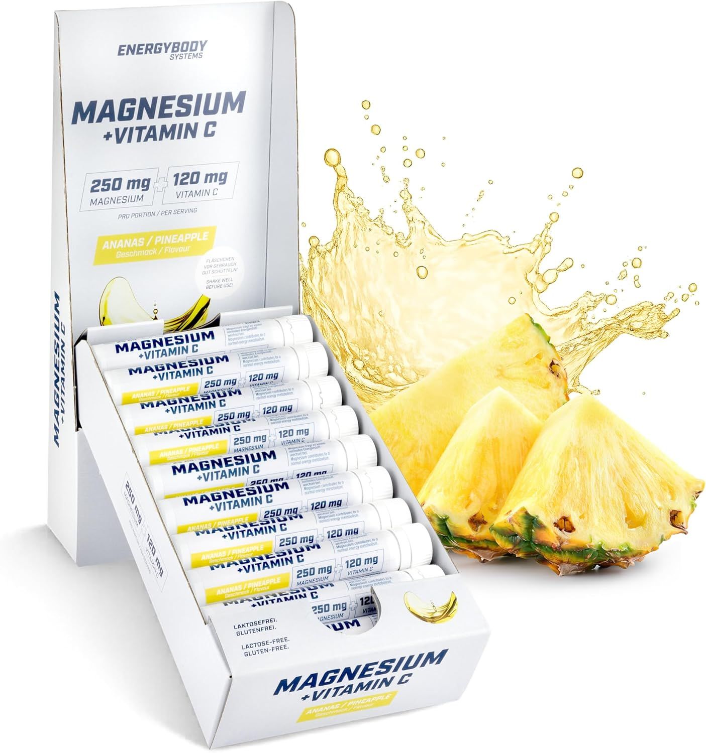 Packung mit Ampullen. Aufschrift: Magnesium + Vitamin C. Ananas-Geschmack. 10 Ampullen in einer Schachtel. Ananas-Stücke daneben.