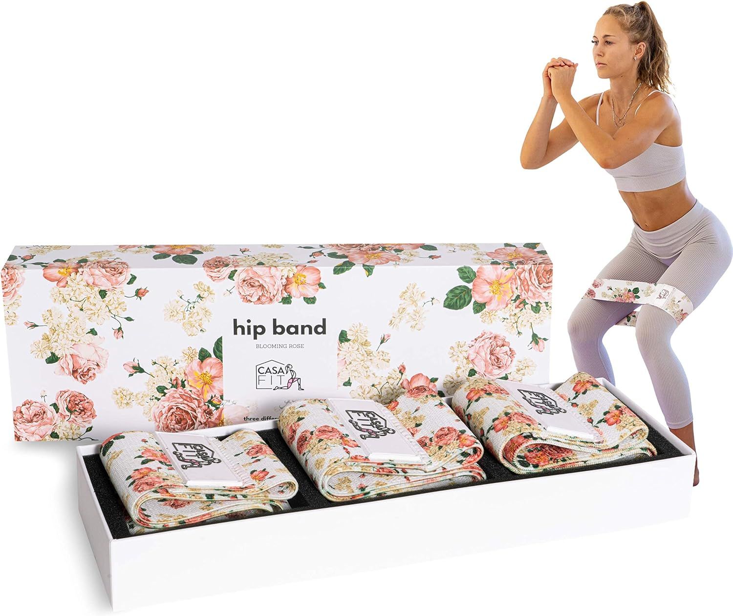 Box mit drei Hüftbändern und Frau beim Squat. Floral bedruckt. Bänder gefaltet. Logo auf Bändern und Box.