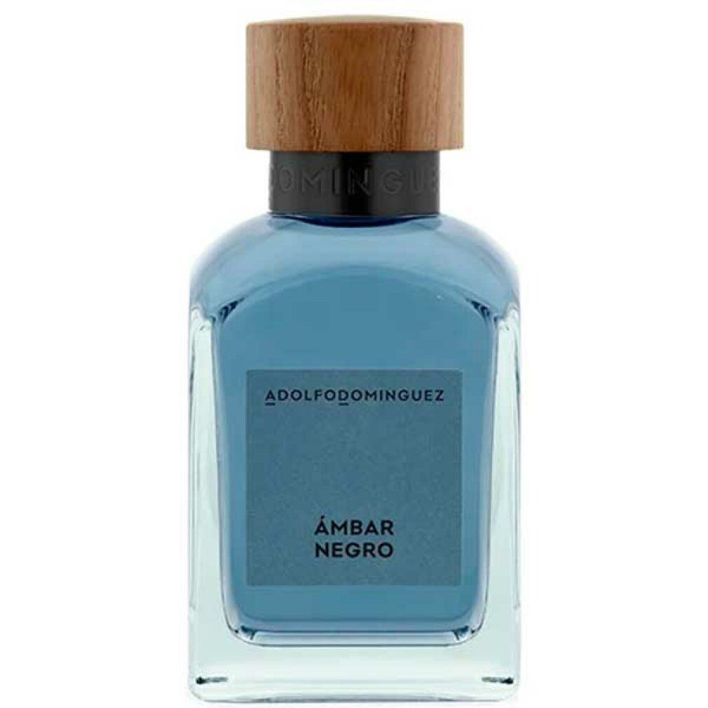 Parfümflasche mit Holzdeckel. Auf dem Etikett steht ADOLFODOMINGUEZ und ÁMBAR NEGRO. Blaue Flüssigkeit in einem quadratischen Glasbehälter.