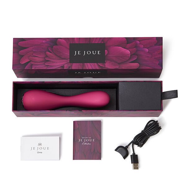 Geöffnete Verpackung mit Vibrator, Ladekabel, Broschüre und Karte. Produktname 'Uma'.