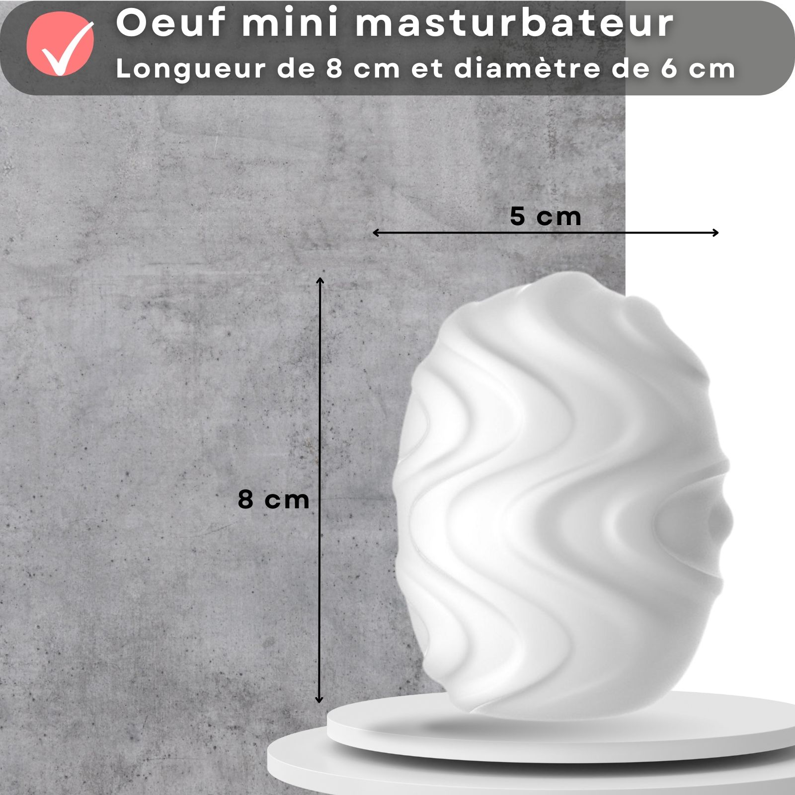 Mini œuf masturbateur blanc, dimensions 8 cm x 5 cm. Sur une plateforme blanche.