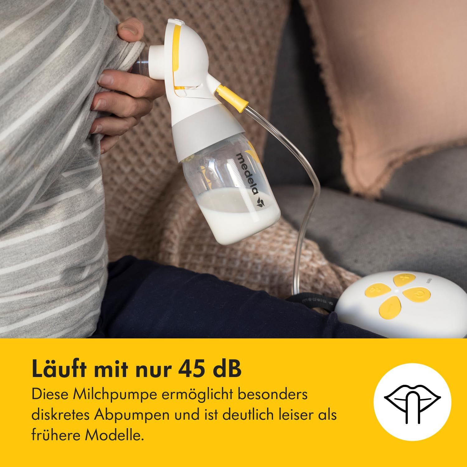 Medela Solo™ Elektrische Milchpumpe. Frau benutzt die Pumpe. Gelber Hintergrund. Leiser Betrieb.