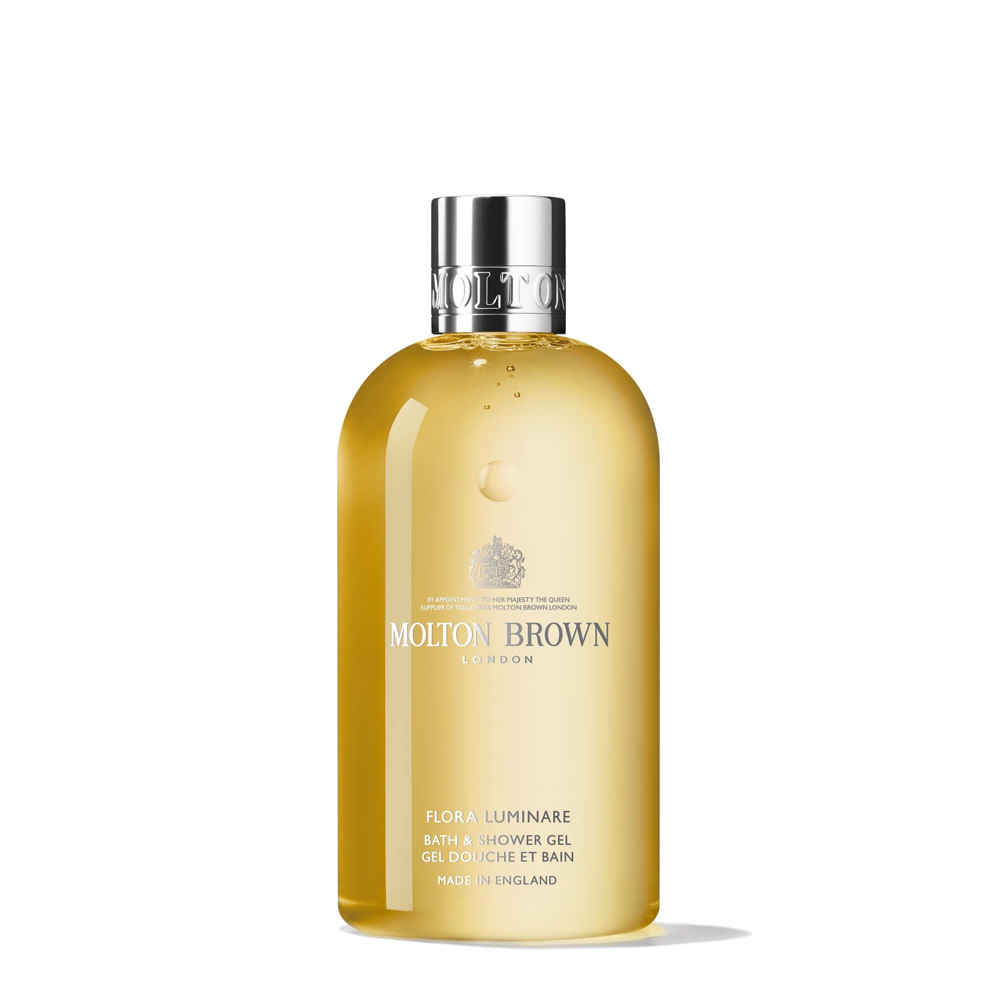 Gelbe Flasche mit silbernem Deckel. Aufschrift: Molton Brown London, Flora Luminare Bath & Shower Gel. Hergestellt in England.