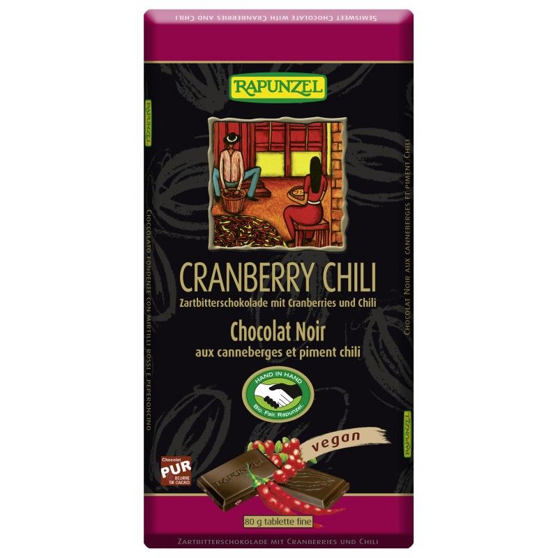 Dunkle Schokoladentafel mit Cranberries und Chili. Verpackung mit Logo und Aufschrift "vegan".