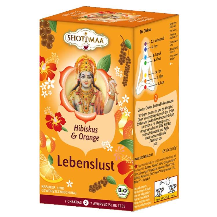 Verpackung von Shoti Maa Chakra Tee. Orangefarbener Karton mit Aufdrucken von Blumen, einer Frau und Text: Hibiskus & Orange, Lebenslust.