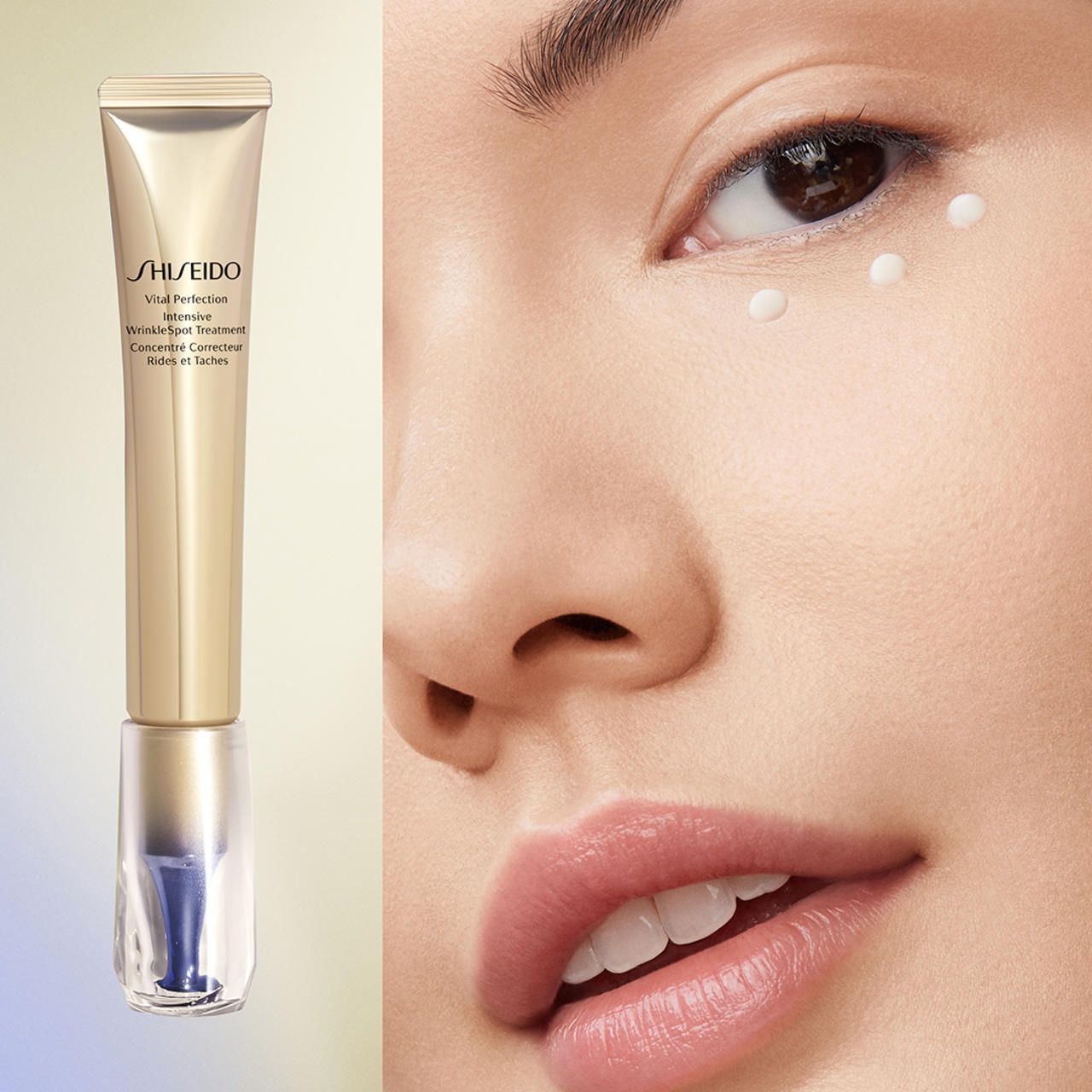 Produkt neben Gesicht. Goldfarbene Tube mit blauem Applikator. Aufschrift: SHISEIDO Vital Perfection Intensive Wrinklespot Treatment.
