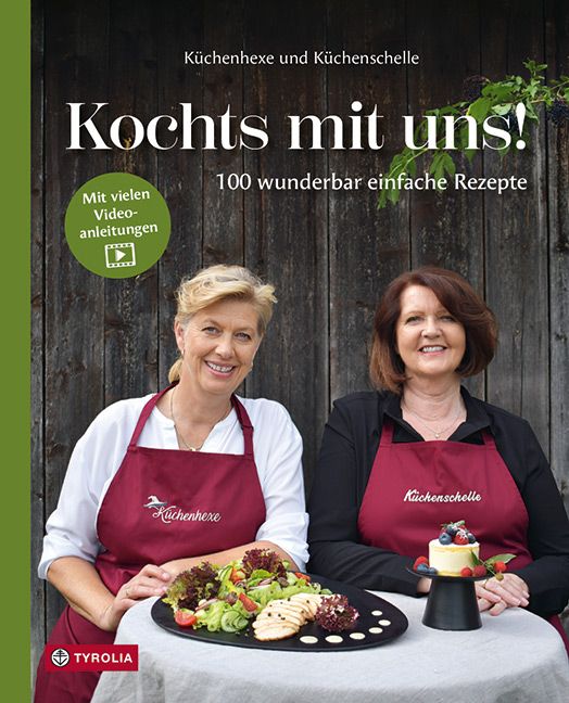 Buchcover: "Kochts mit uns!" mit zwei Frauen, Essen und Logo. Text: 100 einfache Rezepte, Video-Anleitungen.