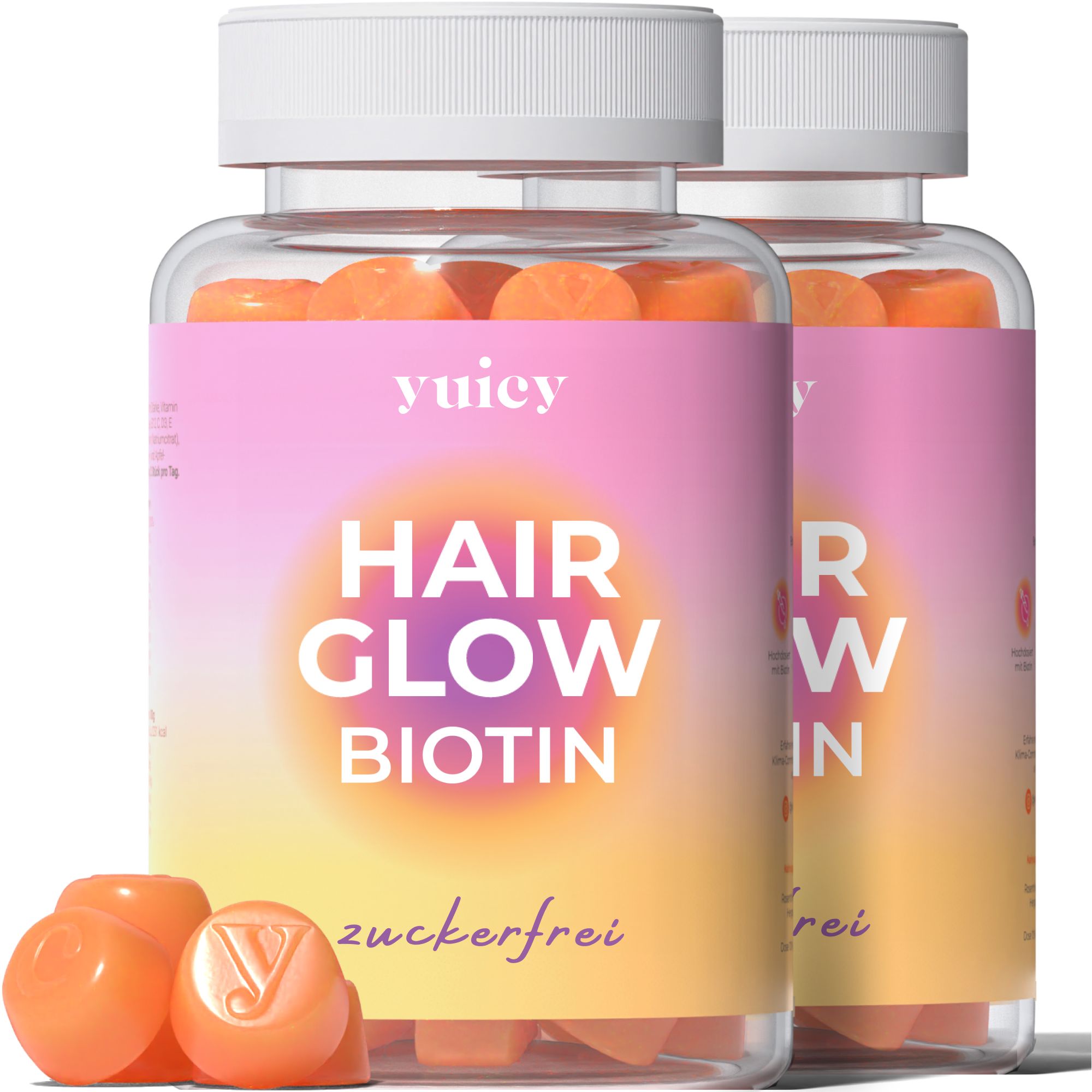 Due bottiglie di caramelle gommose yuicy® Hair Glow Biotin sono affiancate. Le bottiglie sono rosa-gialle e riportano la scritta "Hair Glow Biotin" e "zuckerfrei". Alcune caramelle gommose arancioni sono davanti.