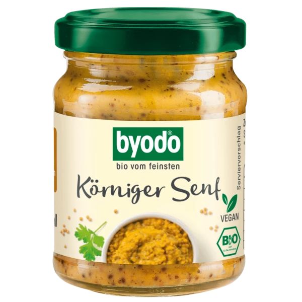 Glas mit körnigem Senf. Grüner Deckel, Etikett mit Logo und Schriftzug. Vegan- und Bio-Siegel.