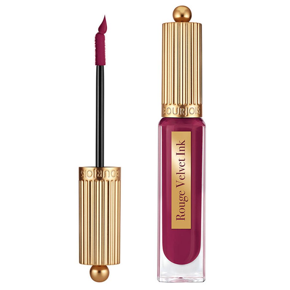 Lippenstift mit goldfarbenem Deckel und Applikator. Der Lippenstift ist geöffnet, der Applikator ist sichtbar.