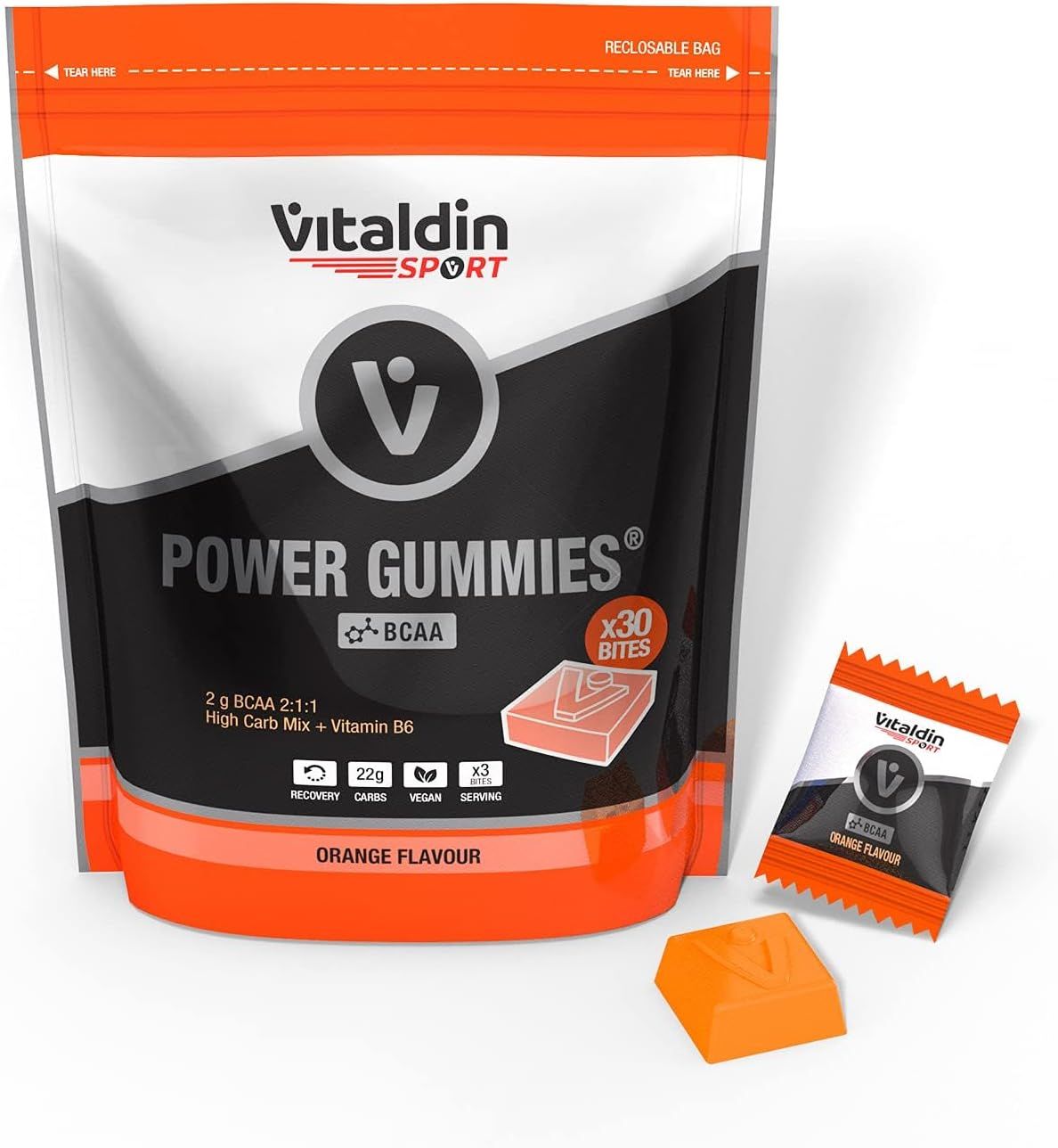 Beutel mit VITALDIN SPORT Power Gummies BCAA. Einzelne Gummibärchen und ein Päckchen daneben. Orangefarbenes Produkt.