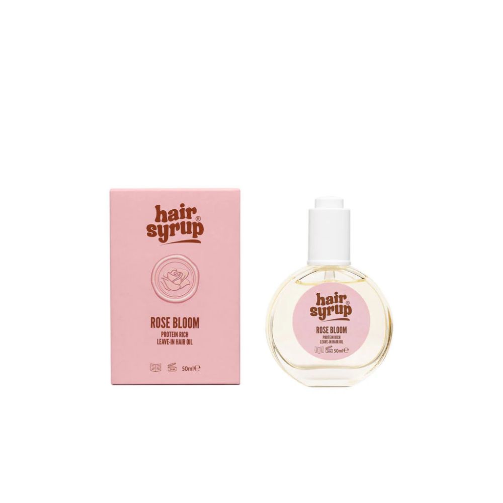 Hair Syrup Rose Bloom Leave-in Haaröl in runder Flasche mit Pipette und rosa Kartonverpackung.