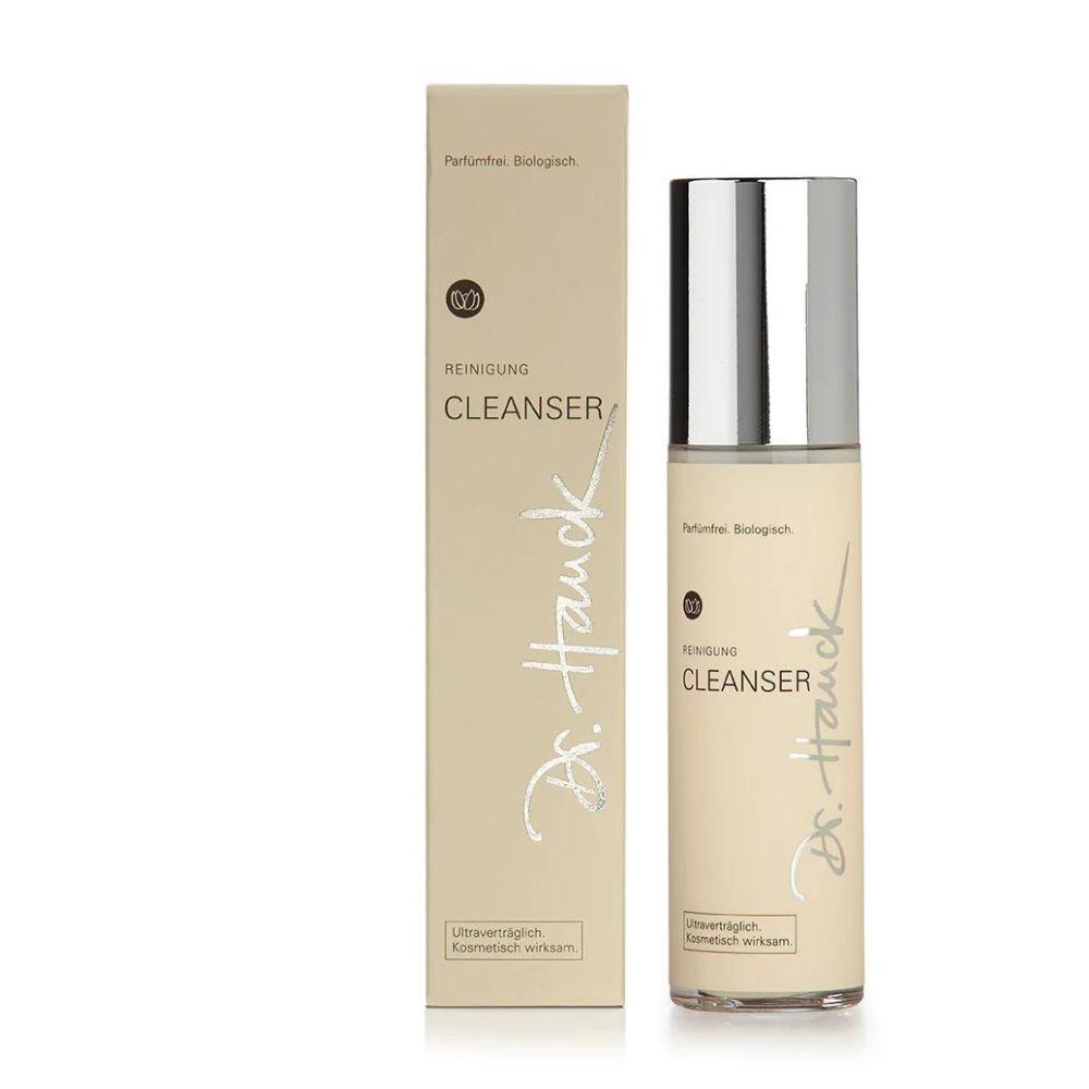 Beige Flasche und Schachtel. Aufschrift: REINIGUNG CLEANSER, Dr. Hauck. Silberner Deckel. Text: Parfümfrei. Biologisch.