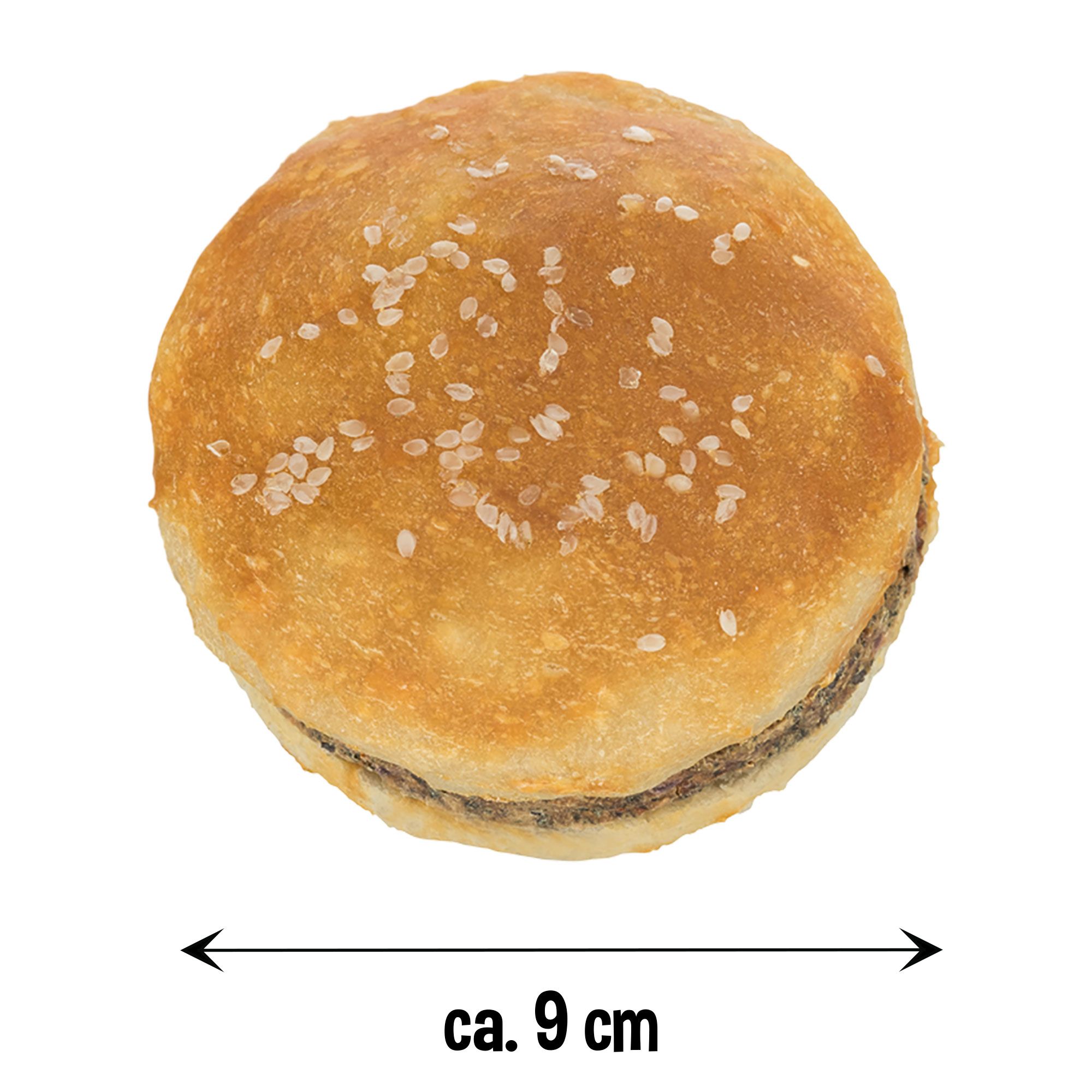 Hunde-Burger, rund, mit hellem Brötchen, dunklem Fleisch und Sesam. Größenangabe: ca. 9 cm.