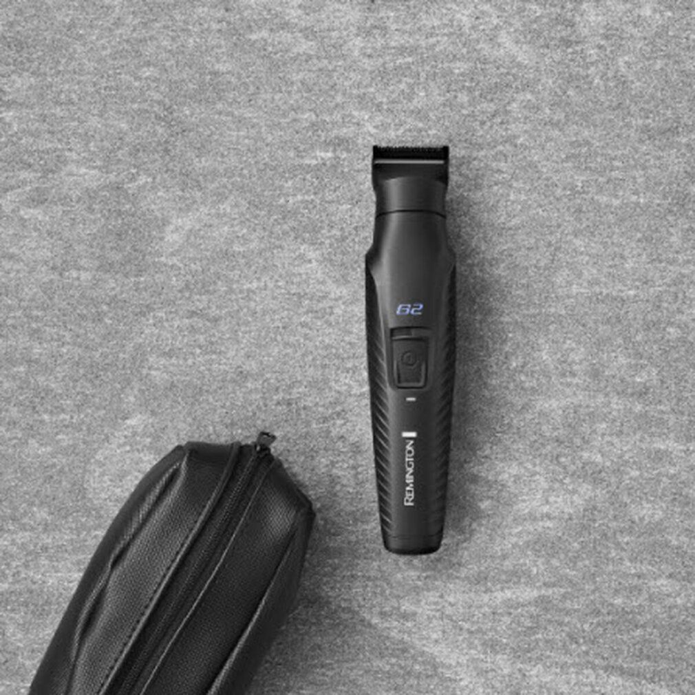 Schwarzer Trimmer und schwarze Tasche auf grauem Hintergrund. G2-Anzeige sichtbar.