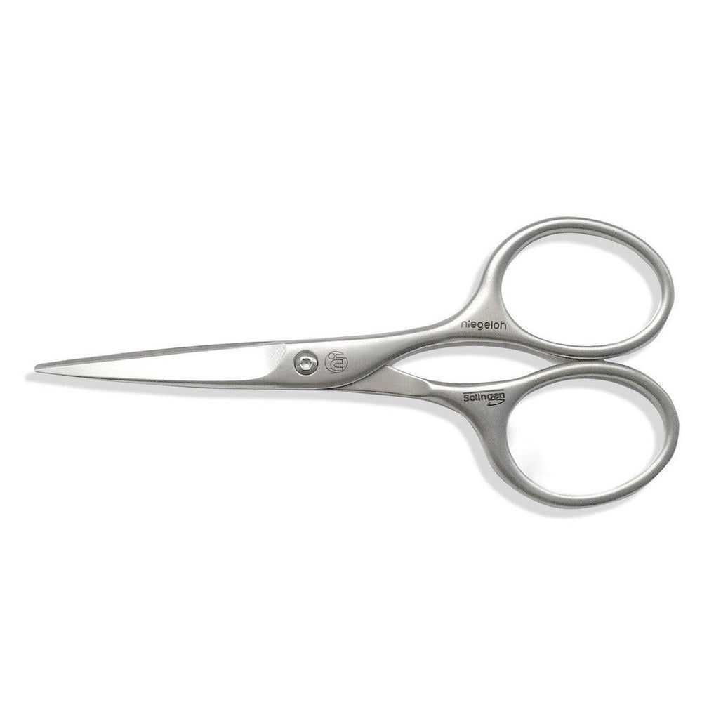 Silberne Niegeloh Solingen Bartschere. Metall, gebogene Griffe, spitz zulaufende Klingen. Markenname und Logo sichtbar.