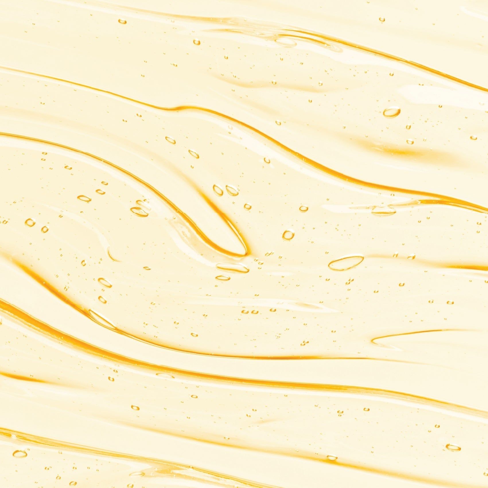 Nahaufnahme von gelbem Serum mit Bläschen. Wellenförmige Struktur.