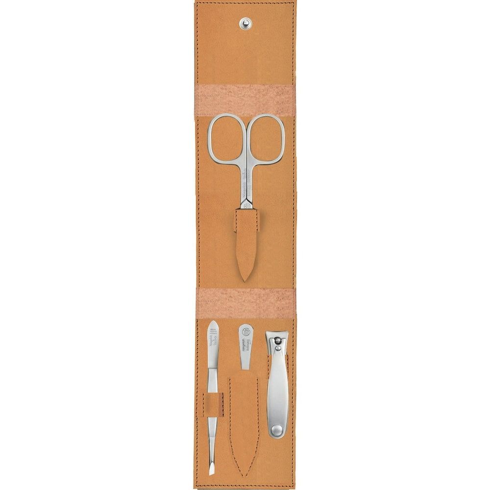 Ledertui mit Maniküre-Set: Schere, Pinzette, Nagelhautschieber und Nagelknipser.