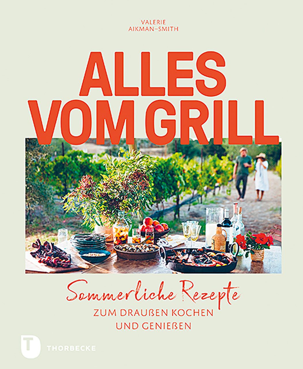 Buchcover mit Titel "ALLES VOM GRILL". Autorin: Valerie Aikman-Smith. Untertitel: Sommerliche Rezepte. Im Hintergrund: gedeckter Tisch im Freien.
