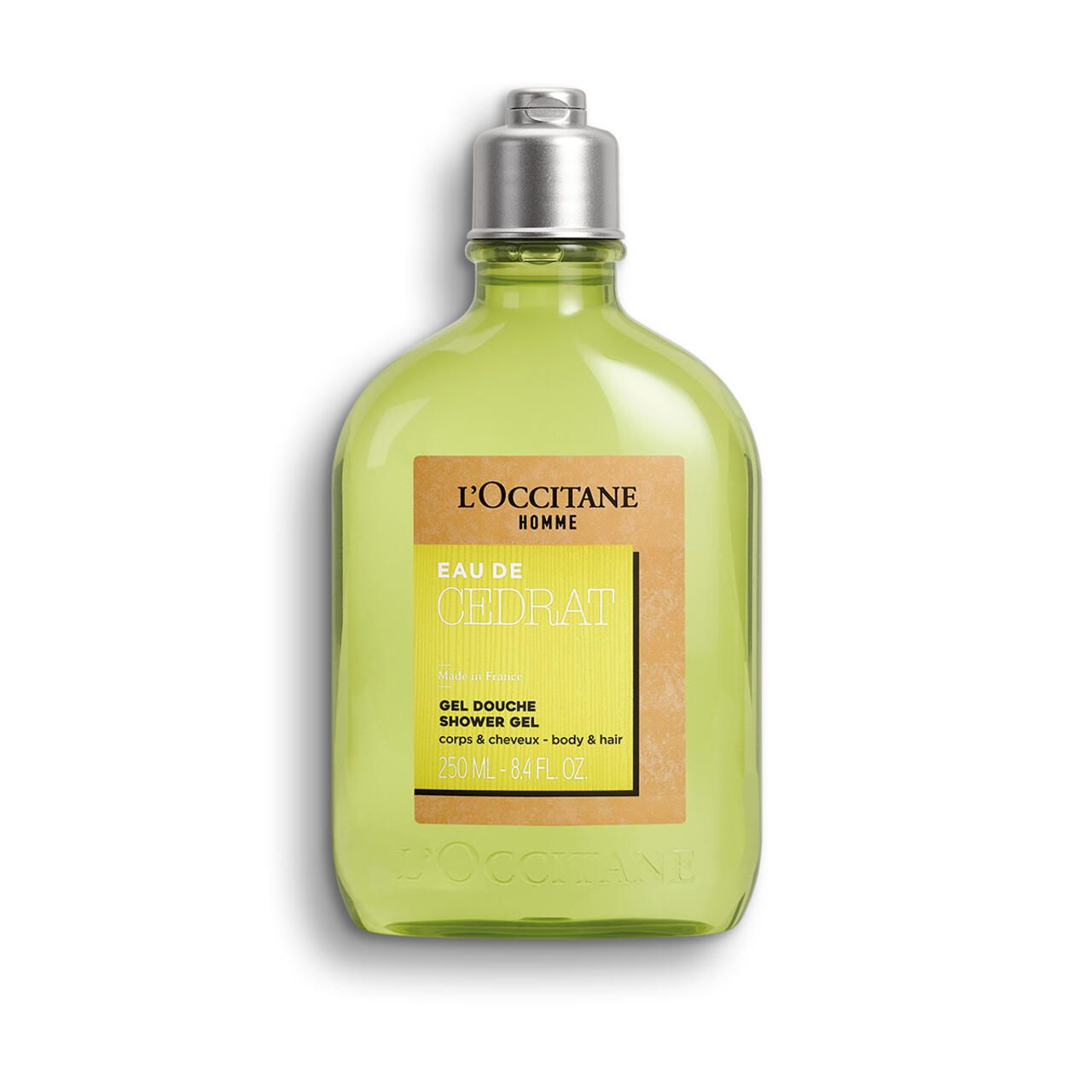 Grünes Duschgel in einer Flasche mit silbernem Deckel. Aufkleber mit Text: Eau de Cédrat, Gel Douche, L'Occitane.