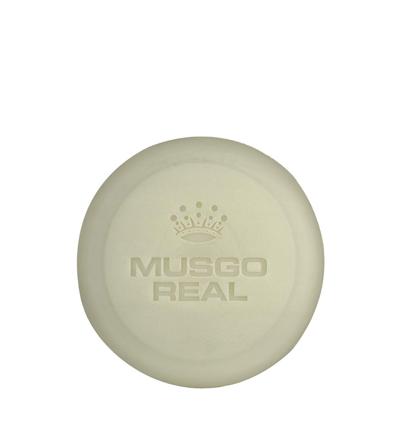 Runde Seife mit geprägtem Logo und Krone. Text: MUSGO REAL.