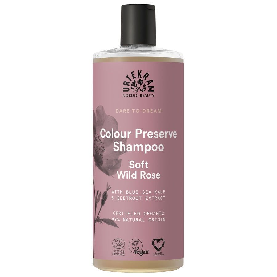 Flasche Shampoo. Rosa Etikett mit Text: Colour Preserve Shampoo Soft Wild Rose. Vegan-Siegel.