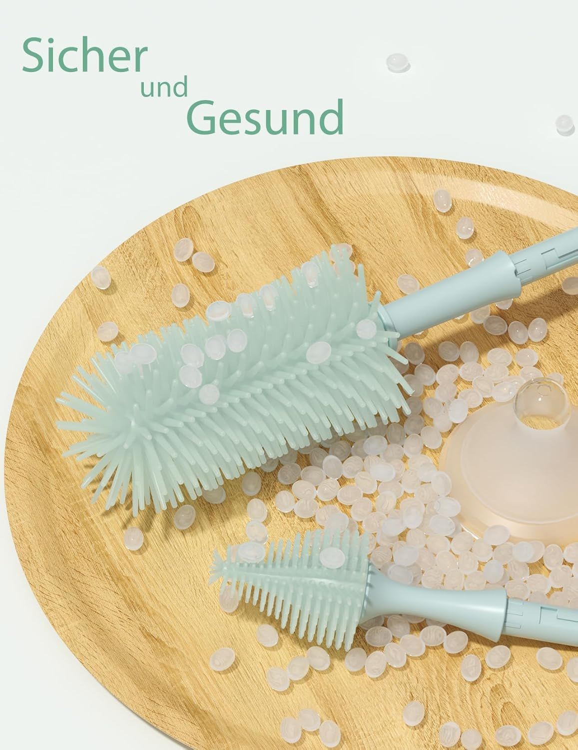 Momcozy Flaschenbürste mit Silikonborsten auf einem Holzteller mit Granulat.