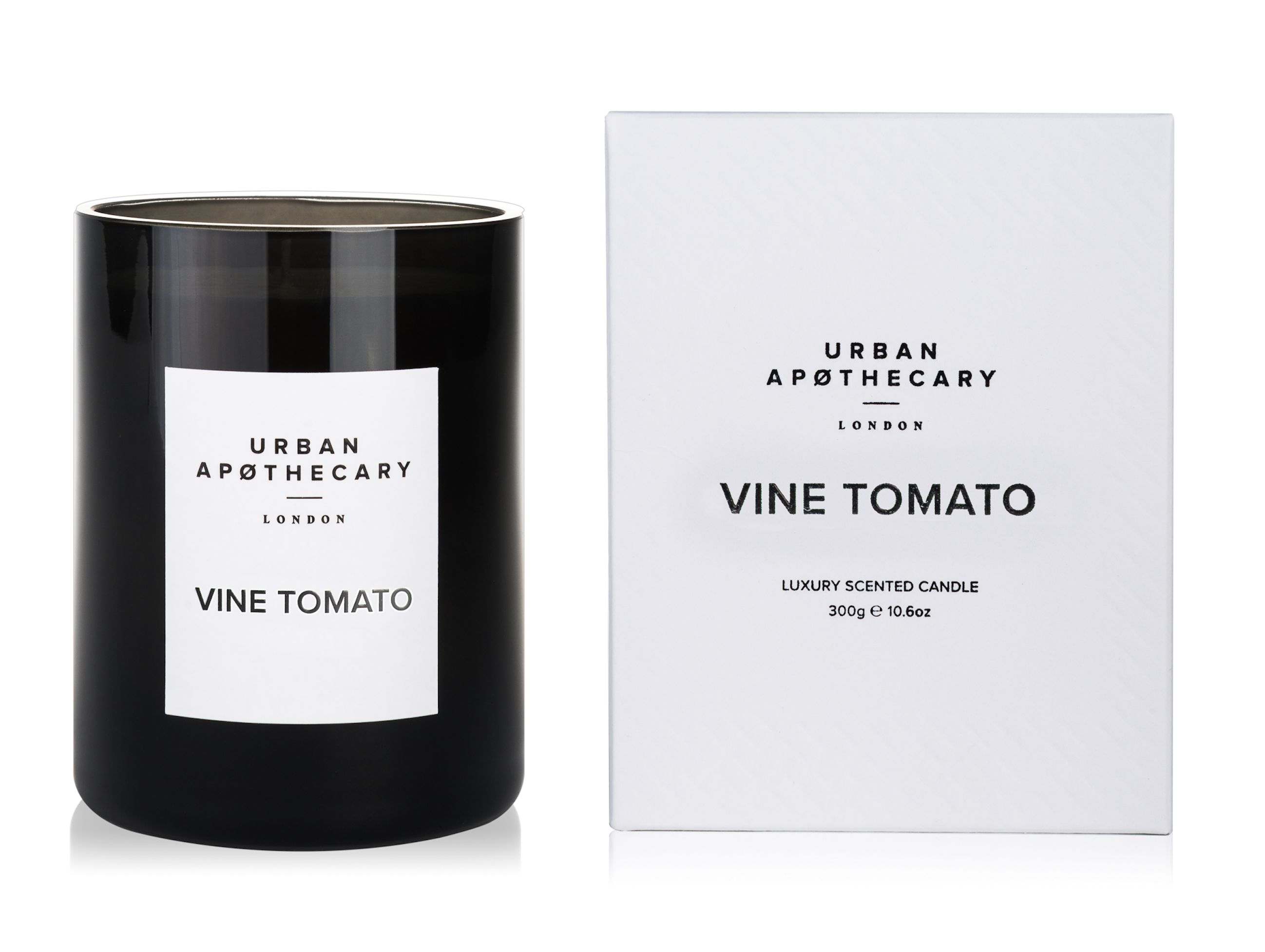Schwarze Kerze und weiße Schachtel. Aufschrift: Urban Apothecary London, Vine Tomato. Luxuriöse Duftkerze.