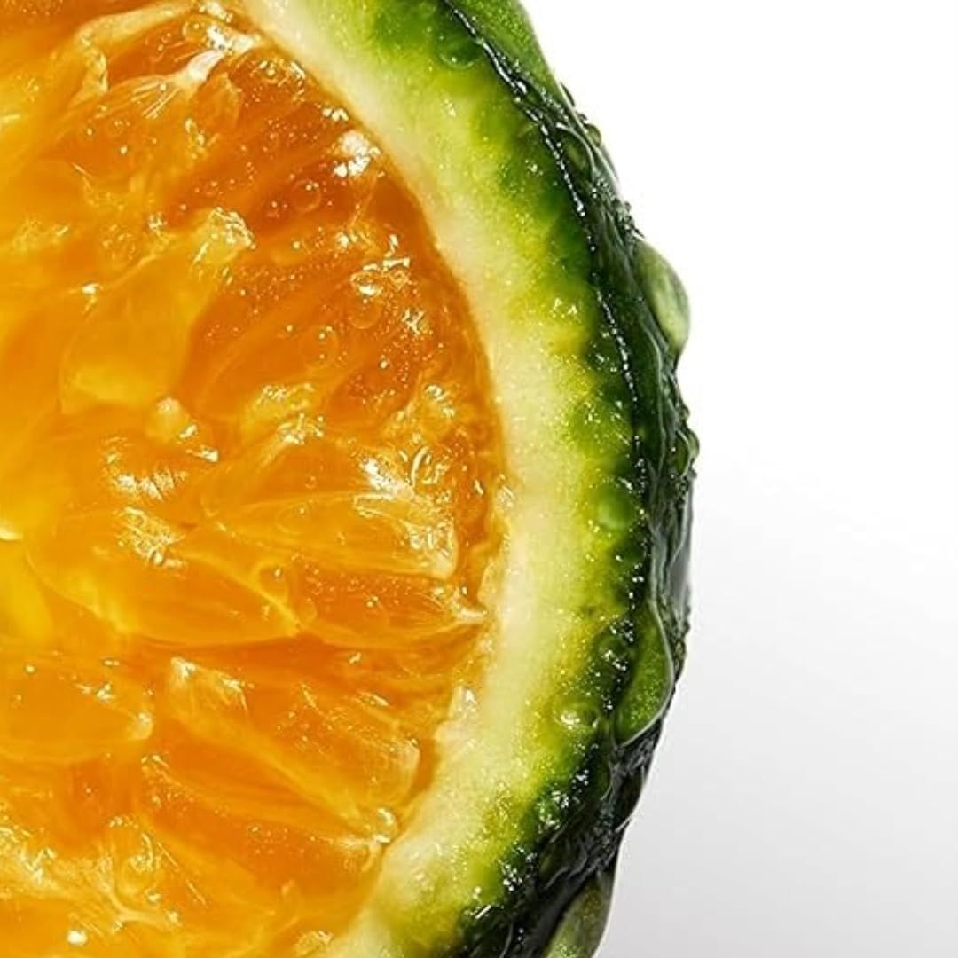 Nahaufnahme einer halbierten Orange. Fruchtfleisch, grüne Schale mit Wassertropfen.