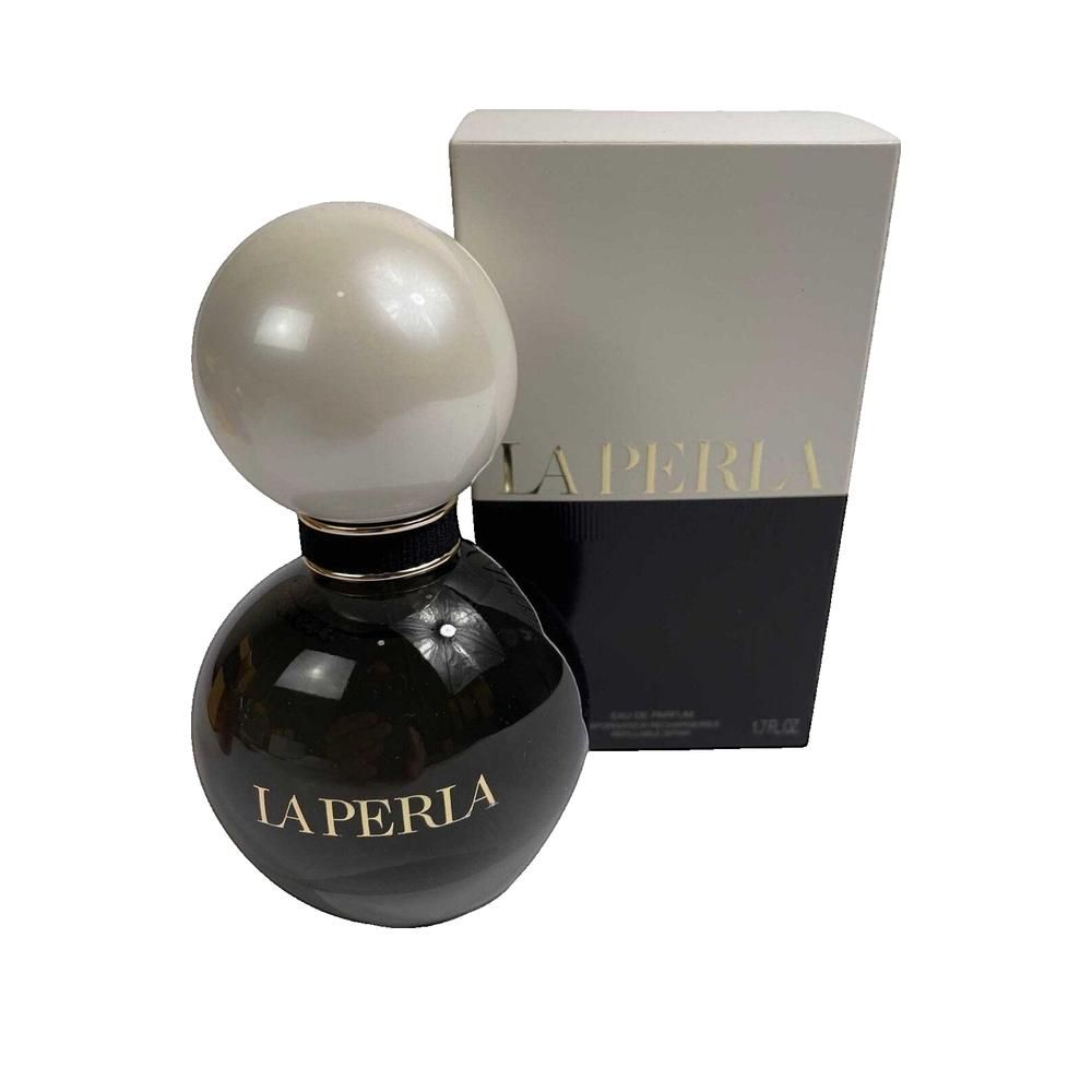 La Perla Eau de Parfum Flakon mit kugelförmigem Verschluss und Umverpackung.