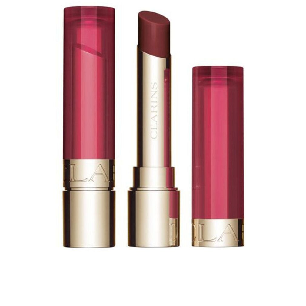 Lippenbalsam mit geöffneter Kappe und Stift. Goldfarbener Boden, transparenter Deckel. Aufschrift.