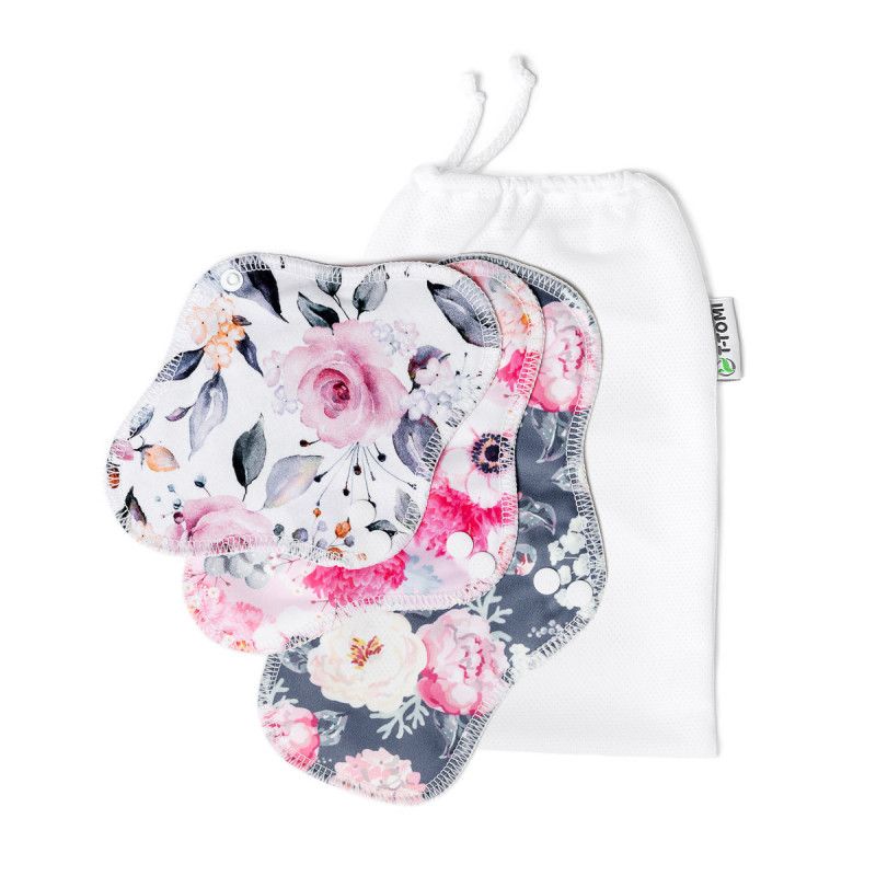 Stoffbinden mit Blumenmuster und weißem Beutel. Marke T-TOMI. Mehrere Binden liegen vor dem Beutel.