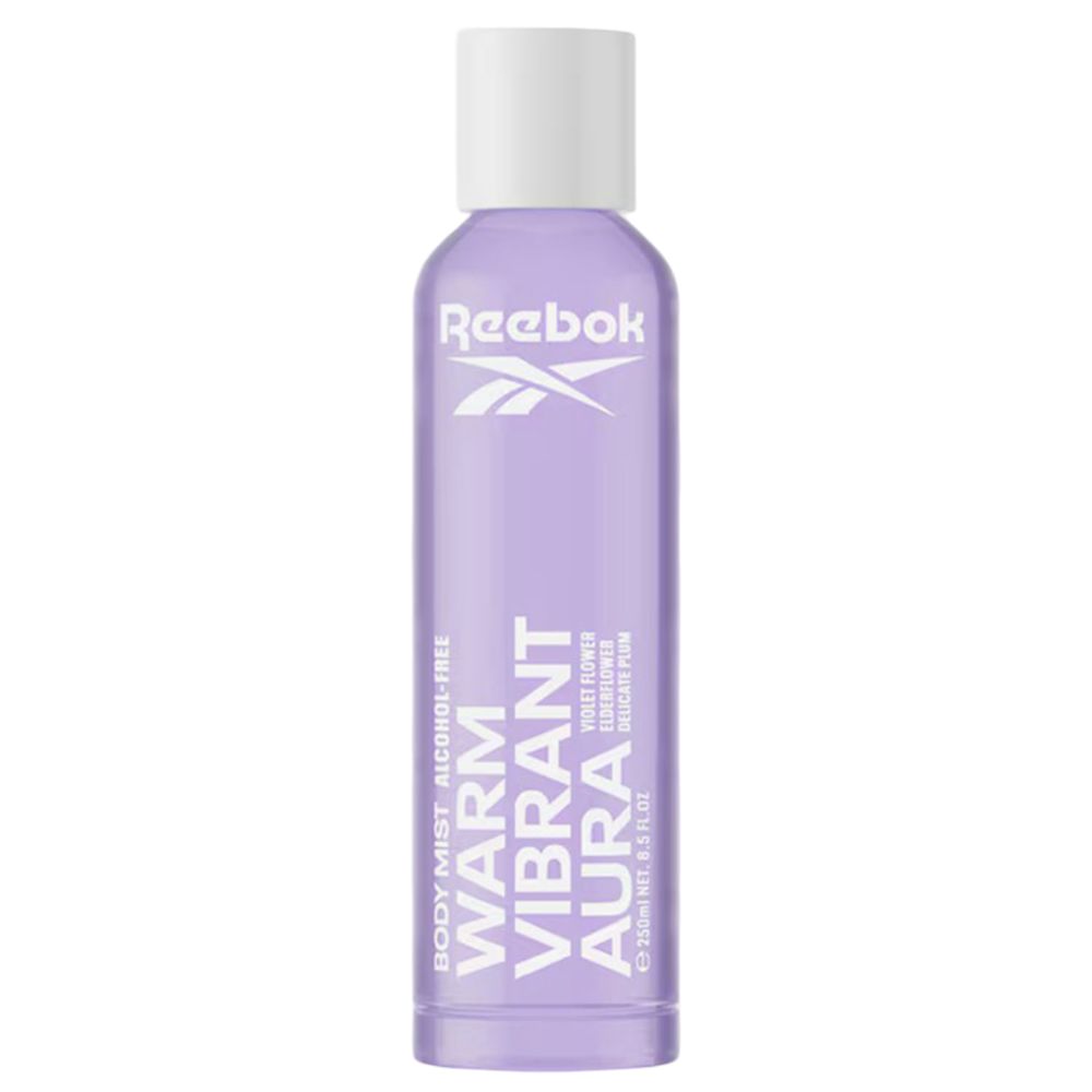 Lila Körperspray mit weißem Deckel. Marke Reebok. Text "Warm Vibrant Aura". Flasche steht aufrecht.