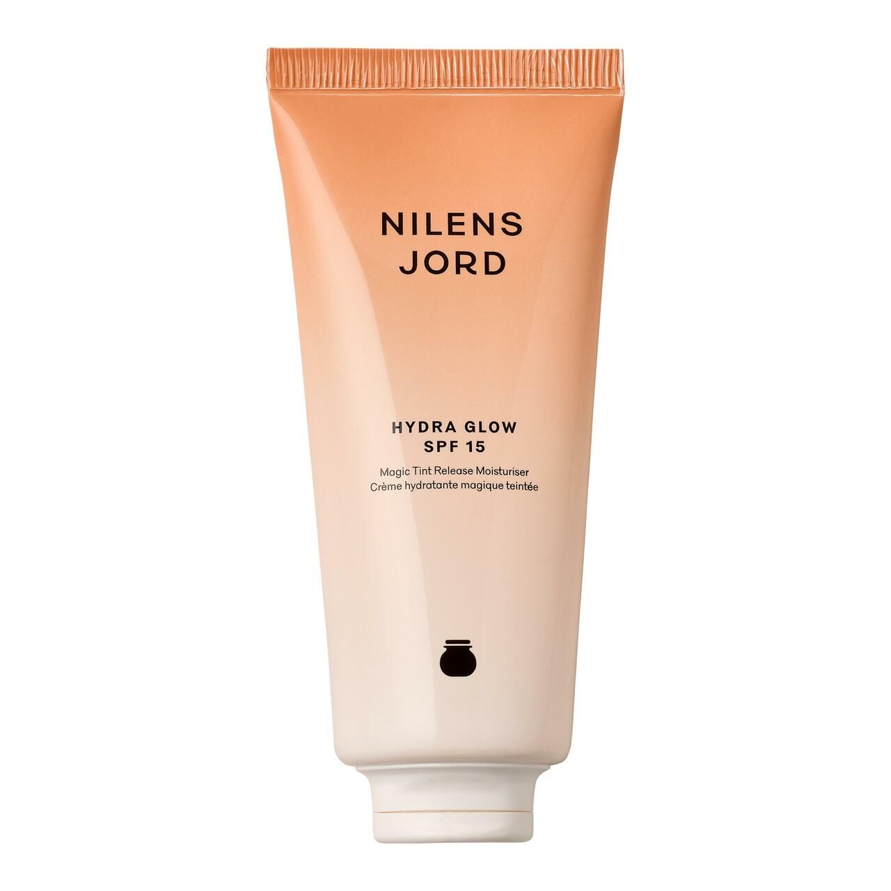 Creme-Tube mit Produktnamen und SPF 15. Farbverlauf von Weiß zu Orange. Schwarzes Logo unten.