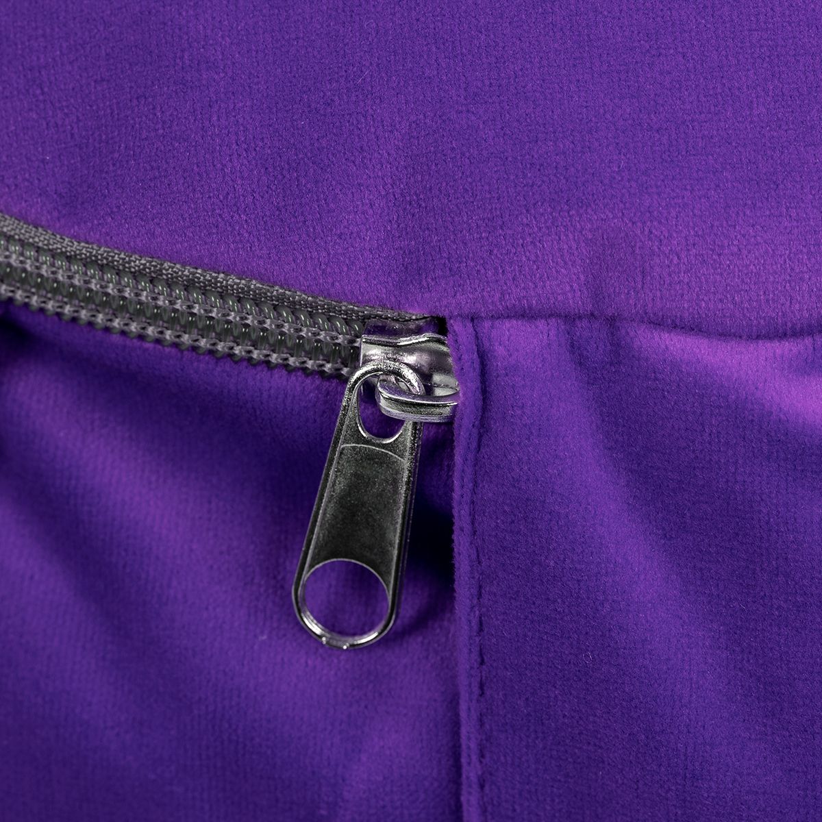 Nahaufnahme des Reißverschlusses eines violetten Meditationskissens.