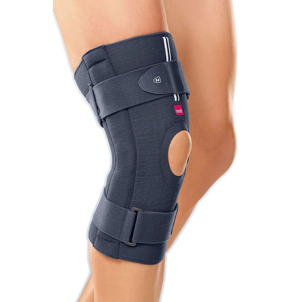 Knieorthese medi Stabimed® pro, grau, am Bein getragen. Kniebereich ausgespart, Klettverschlüsse, seitliche Verstärkungen.