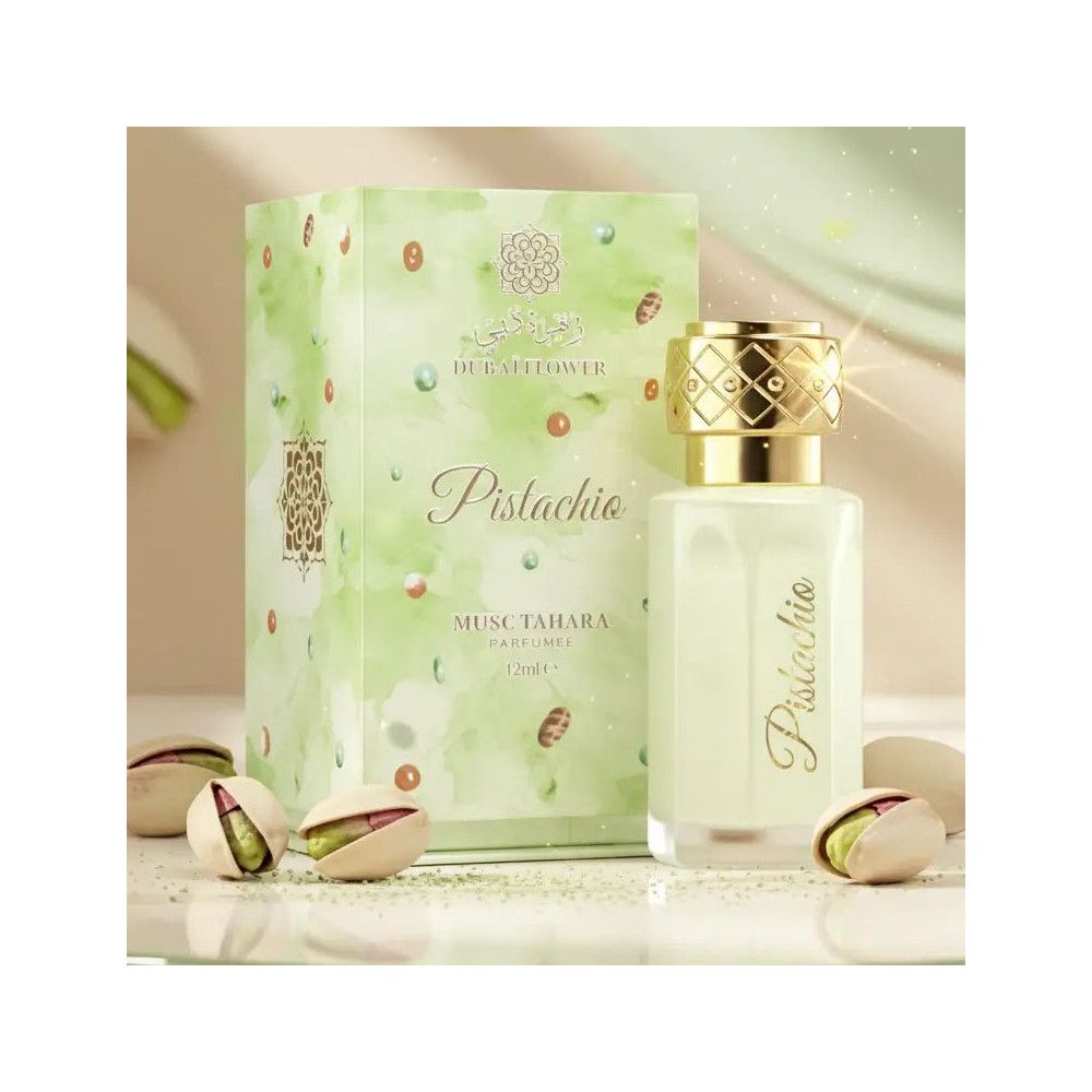 Parfümflasche neben Verpackung und Pistazien. Verpackung mit "Dubai Flower" und "Pistachio" Schriftzug.