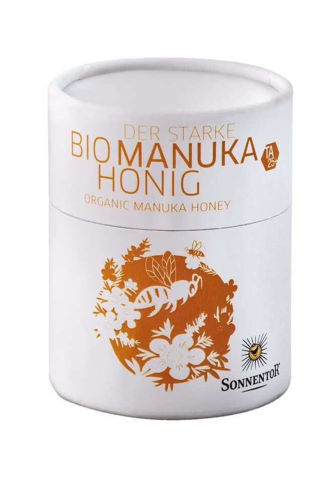 Weiße Dose mit der Aufschrift 'Bio Manuka Honig' und einem Bienen- und Blumenmotiv.