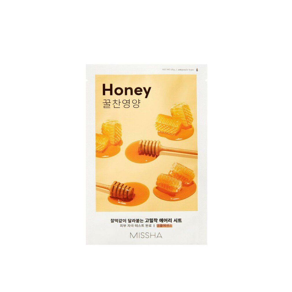 Gesichtsmaske mit Honig-Motiv. Verpackung mit Honigwaben und Honiglöffeln. Schriftzug "Honey" und "MISSHA".
