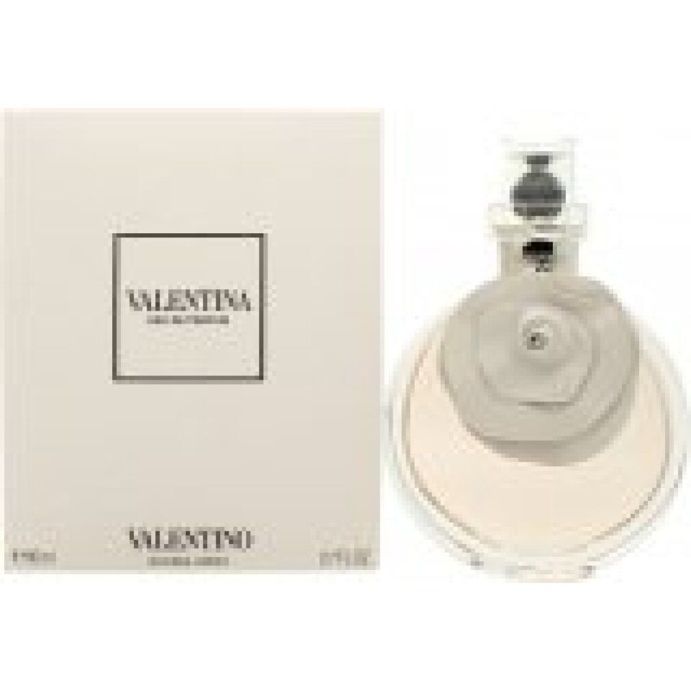 Flakon mit rosafarbenem Inhalt und blütenförmigem Aufsatz. Daneben eine weiße Schachtel mit VALENTINA EAU DE PARFUM-Schriftzug.