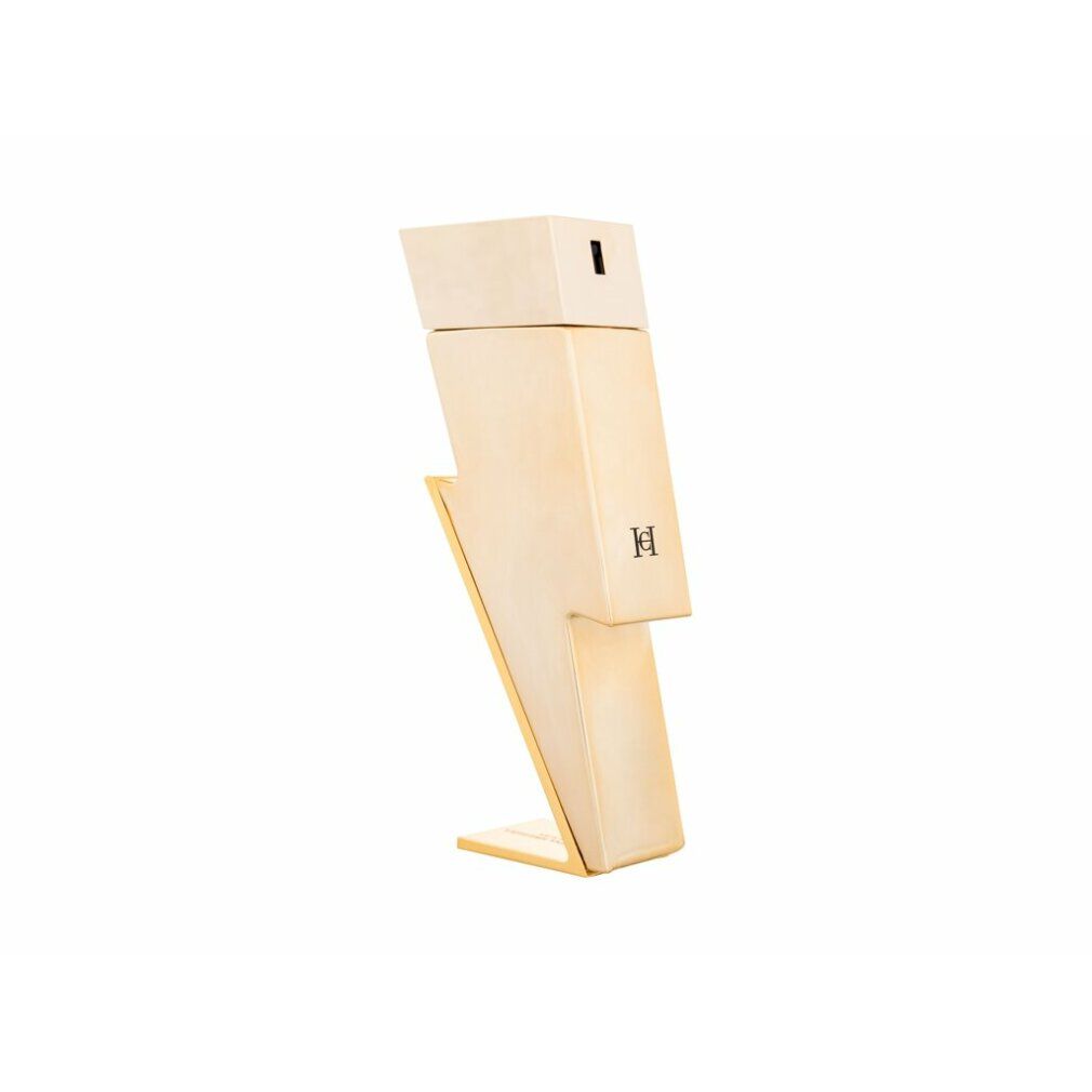 Parfümflakon in Blitzform. Beige-goldene Farbe. Logo auf der Vorderseite. Steht auf einer Basis.