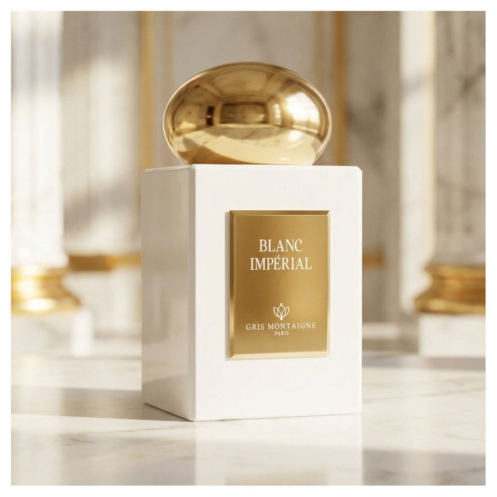 Weißer Flakon mit goldfarbenem Verschluss. Goldene Etikette mit "BLANC IMPÉRIAL" und "GRIS MONTAIGNE PARIS".