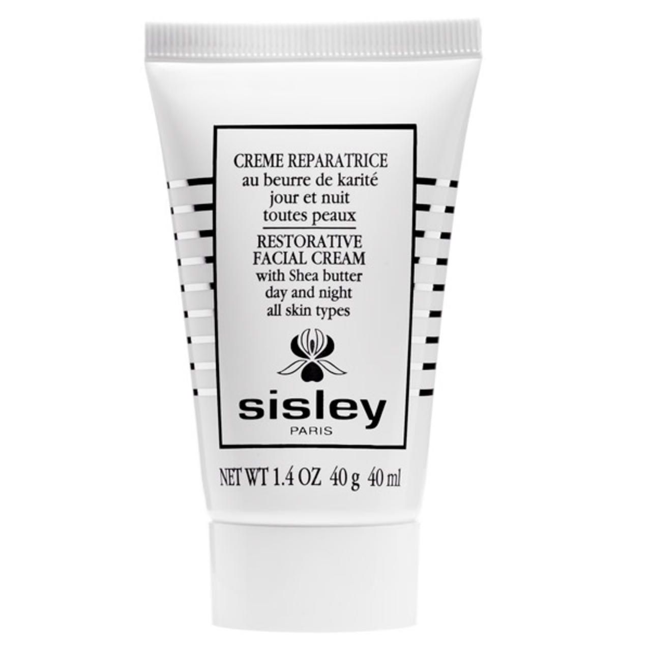 Weiße Tube mit Sisley Creme Reparatrice. Text: Restorative Facial Cream, Shea Butter, Tag und Nacht, alle Hauttypen. 40g.