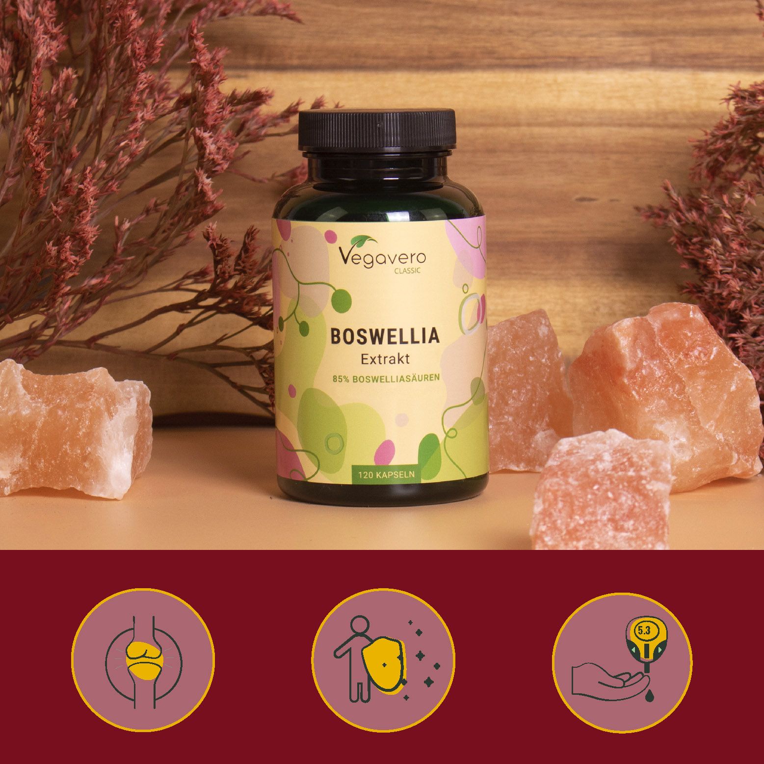 Flasche VEGAVERO Boswellia Extrakt, umgeben von rosa Salzsteinen. Drei Icons: Gelenk, Immunsystem, Tropfen.