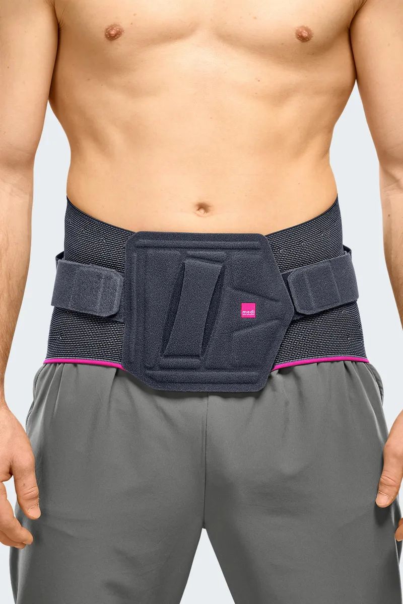 Rückenbandage mit seitlichen Klettverschlüssen und integriertem Polster, von vorne an einem Mann getragen.