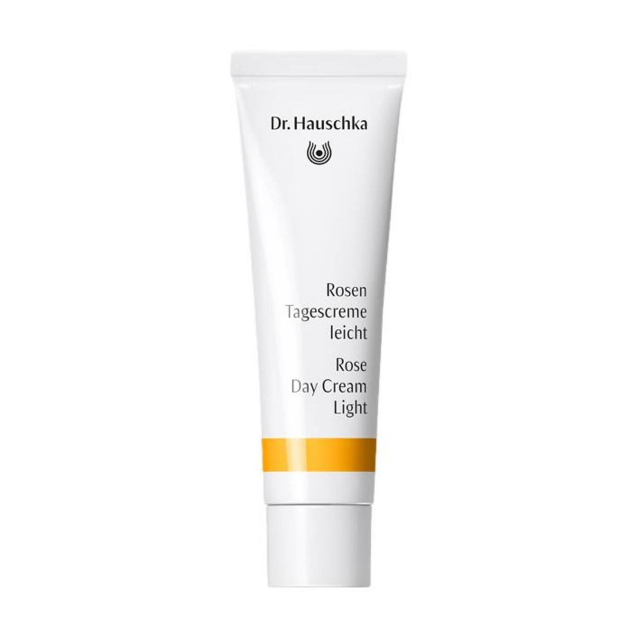 Weiße Tube mit Text. Orangefarbener Streifen. Dr. Hauschka Logo. Rosen Tagescreme leicht.