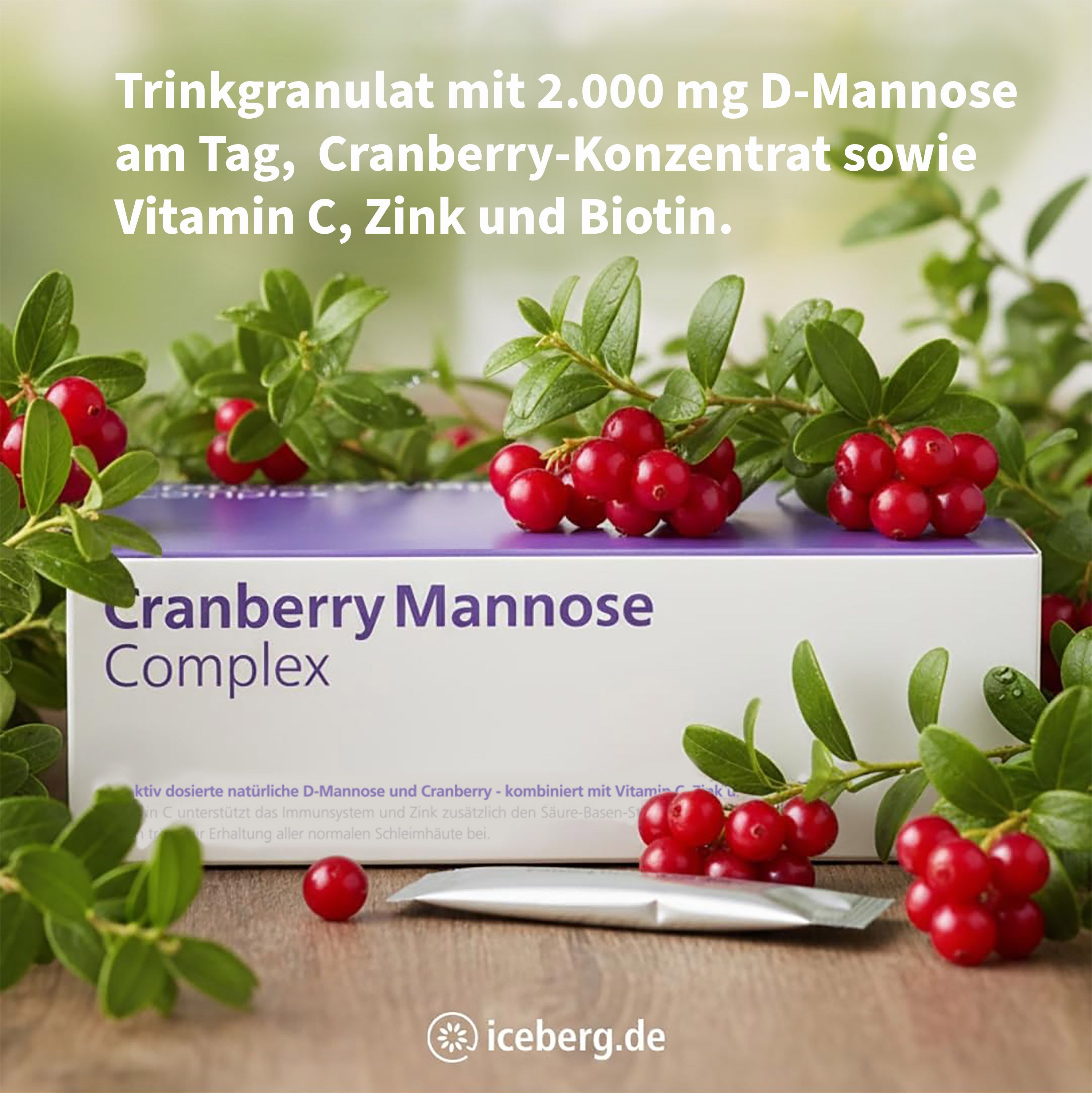 Schachtel Cranberry Mannose Complex, umgeben von Cranberry-Zweigen. Ein Beutel liegt daneben.